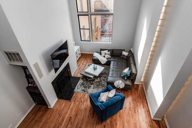 2943 N Lincoln Ave Unit 201, Chicago, IL 60657 - living area featuring wood finished floors, baseboards, and a tile fireplace