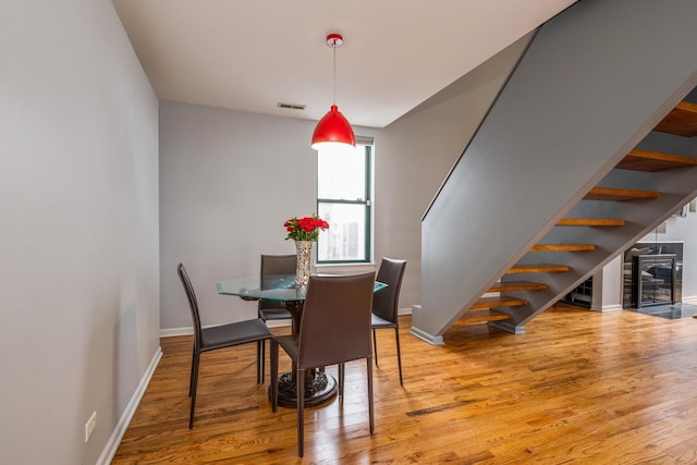 2943 N Lincoln Ave Unit 201, Chicago, IL 60657 - dining space with stairway, wood finished floors, and baseboards