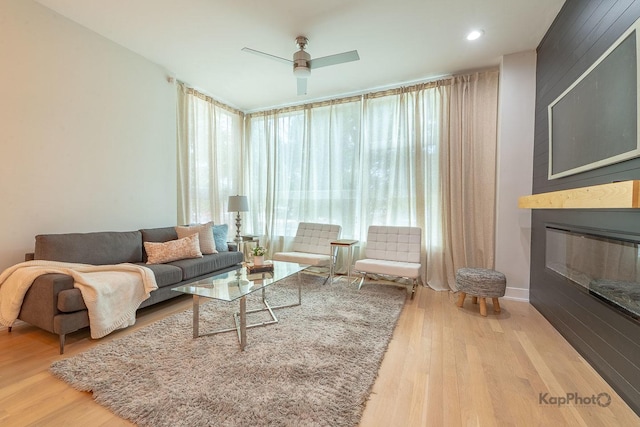 2414 W Grenshaw St Unit 1E, Chicago, IL 60612 - living room with wood finished floors, a fireplace, a wall of windows, and ceiling fan