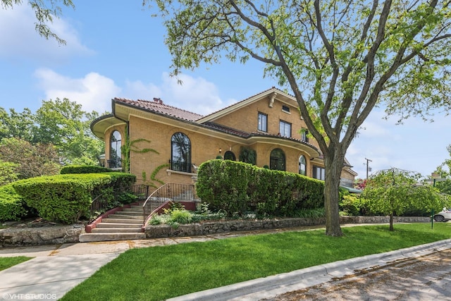 1141 N Ridgeland Ave, Oak Park, IL 60302 - view of front of house with a tiled roof and a front yard