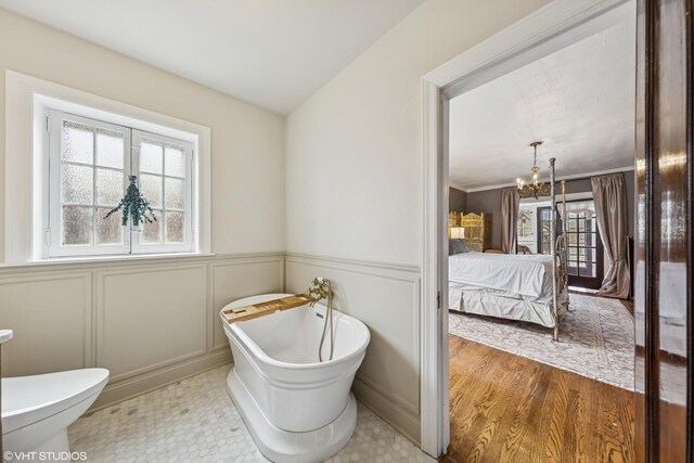 1141 N Ridgeland Ave, Oak Park, IL 60302 - full bath with plenty of natural light, a soaking tub, ensuite bathroom, a chandelier, and wainscoting