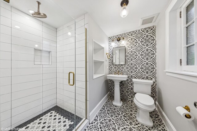 1141 N Ridgeland Ave, Oak Park, IL 60302 - bathroom featuring a shower stall, baseboards, toilet, and tile patterned flooring
