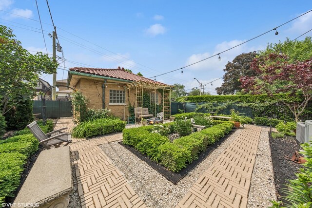 1141 N Ridgeland Ave, Oak Park, IL 60302 - rear view of property with a tiled roof and a garden