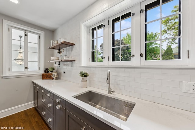 1141 N Ridgeland Ave, Oak Park, IL 60302 - kitchen with a sink, baseboards, decorative backsplash, dark wood-style flooring, and dark brown cabinets