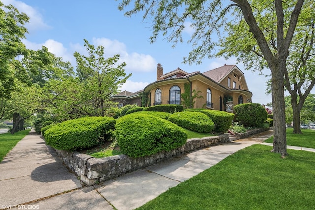 1141 N Ridgeland Ave, Oak Park, IL 60302 - view of front facade featuring a front yard, a chimney, and stucco siding