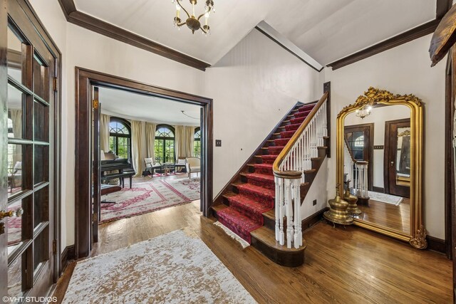 1141 N Ridgeland Ave, Oak Park, IL 60302 - entryway with ornamental molding, stairway, wood finished floors, a chandelier, and baseboards