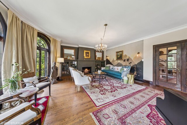 1141 N Ridgeland Ave, Oak Park, IL 60302 - living area with crown molding, a large fireplace, a chandelier, and wood finished floors