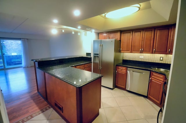 5848 W 76th Pl Unit 202, Burbank, IL 60459 - kitchen featuring appliances with stainless steel finishes, decorative backsplash, light tile patterned floors, dark stone counters, and a raised ceiling