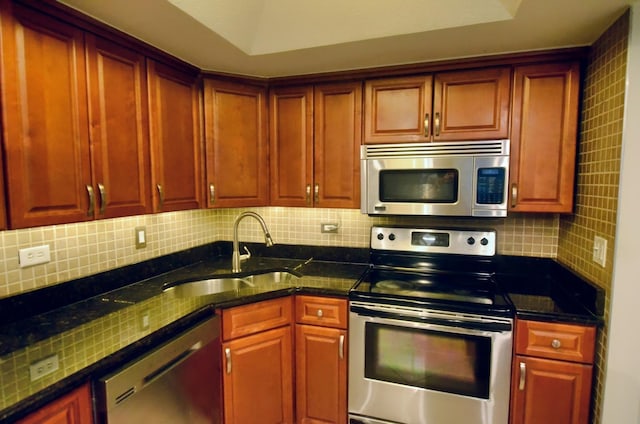 5848 W 76th Pl Unit 202, Burbank, IL 60459 - kitchen featuring appliances with stainless steel finishes, dark brown cabinets, decorative backsplash, and a sink