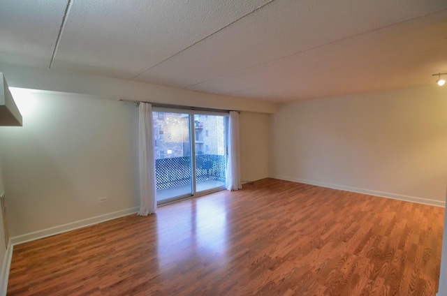 5848 W 76th Pl Unit 202, Burbank, IL 60459 - unfurnished room featuring wood finished floors, baseboards, and a textured ceiling