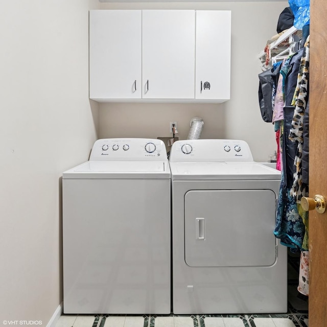 1140 W Barry Ave, Chicago, IL 60657 - laundry room with cabinet space, washing machine and dryer, and light tile patterned floors