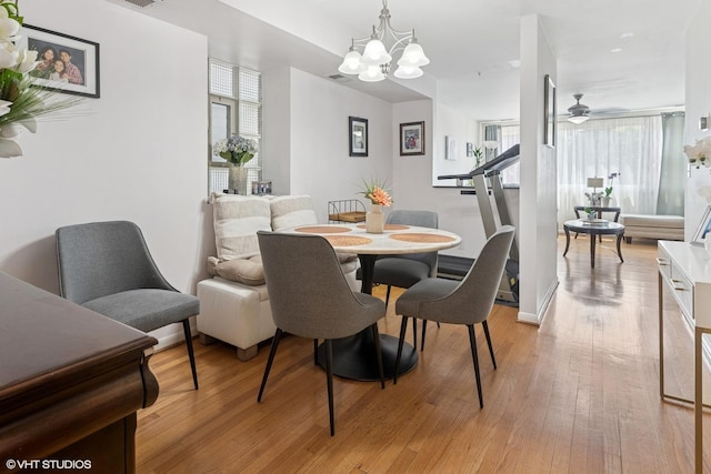 1140 W Barry Ave, Chicago, IL 60657 - dining space with a chandelier, light wood-type flooring, and a ceiling fan