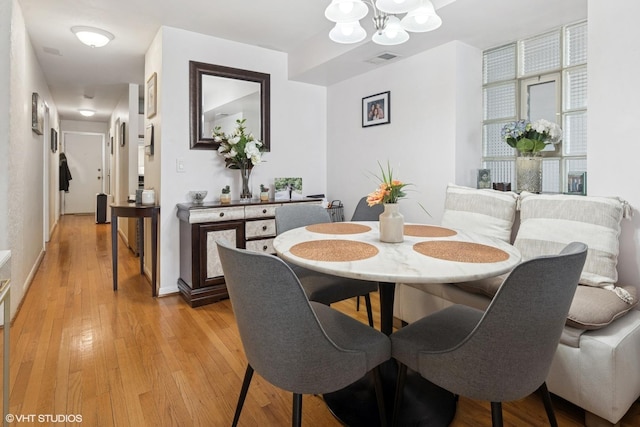 1140 W Barry Ave, Chicago, IL 60657 - dining space featuring a chandelier and light wood-type flooring