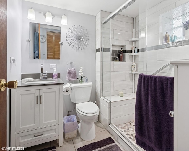 1140 W Barry Ave, Chicago, IL 60657 - bathroom with vanity, tile patterned flooring, and a stall shower