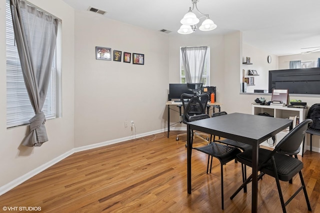 1140 W Barry Ave, Chicago, IL 60657 - dining room with a desk, light wood-type flooring, healthy amount of natural light, and a chandelier