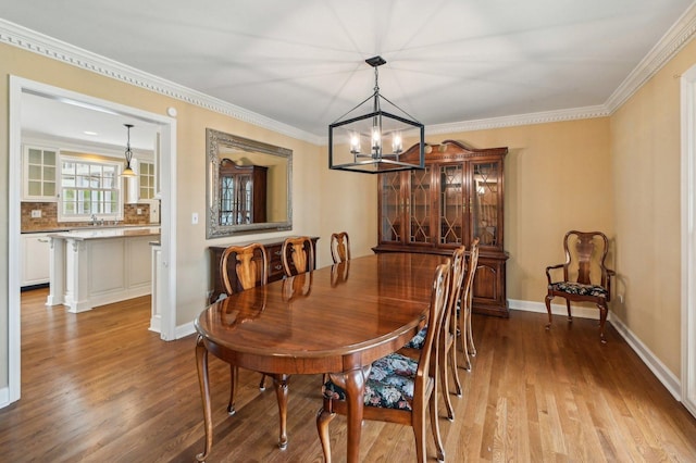 21956 N Hickory Hill Dr, Kildeer, IL 60047 - dining room featuring a chandelier, wood finished floors, crown molding, and baseboards