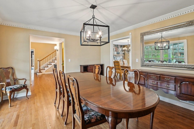 21956 N Hickory Hill Dr, Kildeer, IL 60047 - dining space with a chandelier, wood finished floors, stairway, and crown molding
