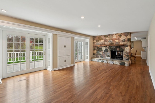 21956 N Hickory Hill Dr, Kildeer, IL 60047 - unfurnished living room with wood finished floors, a stone fireplace, baseboards, and recessed lighting