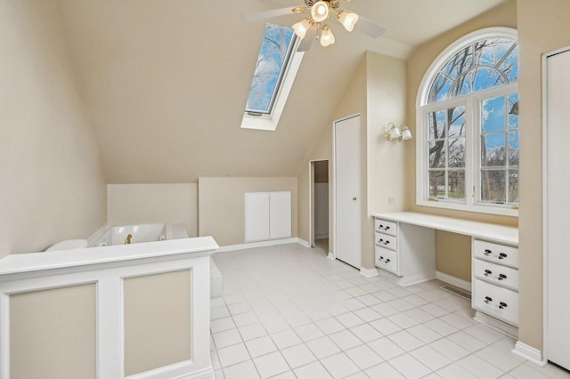 21956 N Hickory Hill Dr, Kildeer, IL 60047 - full bathroom featuring vaulted ceiling, a garden tub, a ceiling fan, a skylight, and baseboards