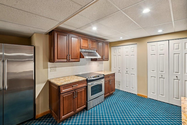 21956 N Hickory Hill Dr, Kildeer, IL 60047 - kitchen with stainless steel appliances, under cabinet range hood, recessed lighting, dark carpet, and decorative backsplash