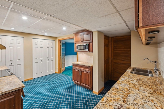 21956 N Hickory Hill Dr, Kildeer, IL 60047 - kitchen with a sink, stainless steel microwave, dark carpet, recessed lighting, and light stone countertops