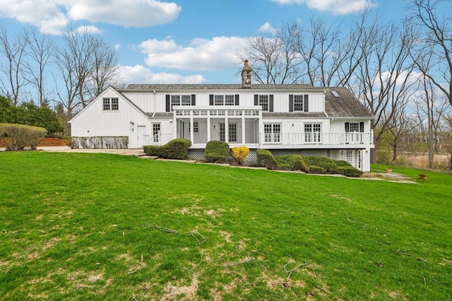 21956 N Hickory Hill Dr, Kildeer, IL 60047 - back of property with a chimney, a deck, board and batten siding, and a yard