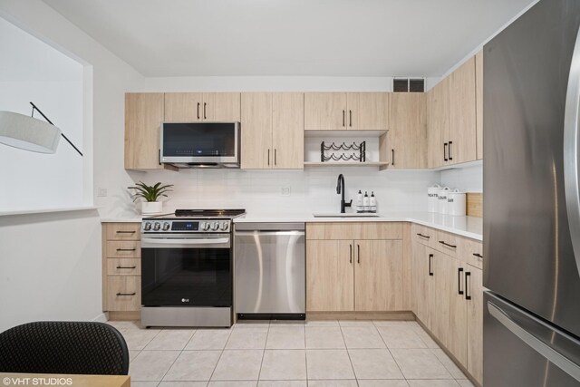 211 E Ohio St Unit 2819, Chicago, IL 60611 - kitchen with stainless steel appliances, light brown cabinets, a sink, tasteful backsplash, and light countertops