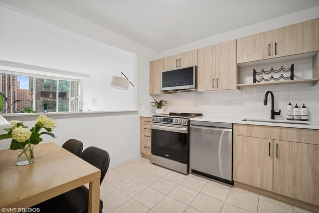 211 E Ohio St Unit 2819, Chicago, IL 60611 - kitchen with stainless steel appliances, light brown cabinets, a sink, and open shelves