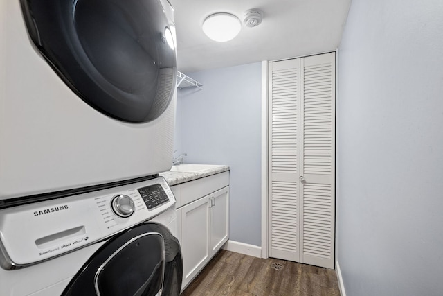 16906 Grissom Dr, Tinley Park, IL 60477 - laundry area with stacked washer and clothes dryer, cabinet space, dark wood-style floors, and baseboards