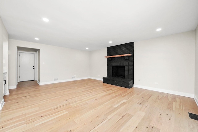 14814 Oakcreek Ct, Orland Park, IL 60467 - unfurnished living room featuring a brick fireplace, light wood-style floors, and recessed lighting