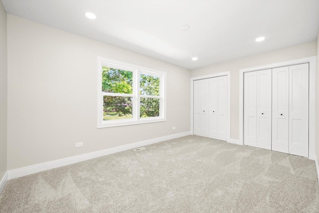 14814 Oakcreek Ct, Orland Park, IL 60467 - unfurnished bedroom with multiple closets, carpet, and recessed lighting
