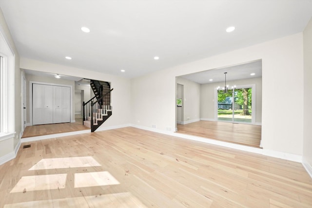 14814 Oakcreek Ct, Orland Park, IL 60467 - empty room featuring stairway, light wood finished floors, a chandelier, and recessed lighting
