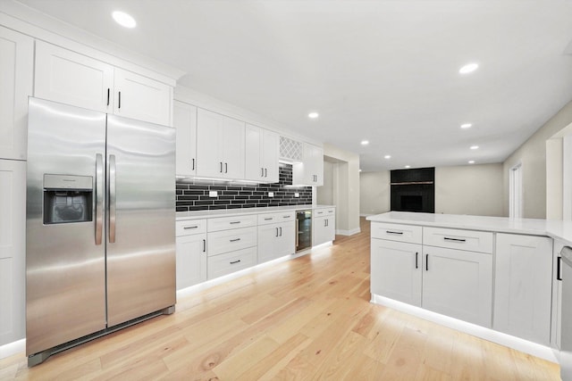 14814 Oakcreek Ct, Orland Park, IL 60467 - kitchen featuring stainless steel refrigerator with ice dispenser, beverage cooler, light wood finished floors, white cabinetry, and tasteful backsplash