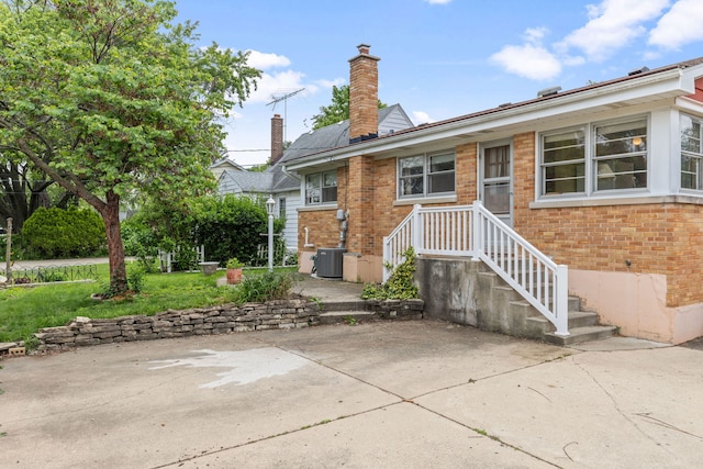 493 W Avery St, Elmhurst, IL 60126 - back of property featuring brick siding, a chimney, a patio area, and cooling unit