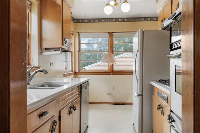 493 W Avery St, Elmhurst, IL 60126 - kitchen featuring a sink, light countertops, stainless steel dishwasher, a chandelier, and freestanding refrigerator