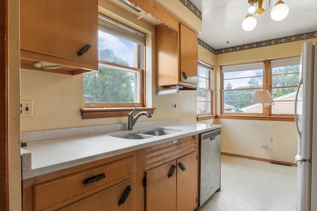 493 W Avery St, Elmhurst, IL 60126 - kitchen featuring a sink, stainless steel dishwasher, freestanding refrigerator, light flooring, and a chandelier