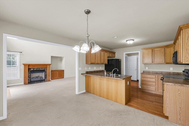 2303 Blanche Ln Unit B, Champaign, IL 61822 - kitchen featuring black appliances, open floor plan, a peninsula, light carpet, and a chandelier