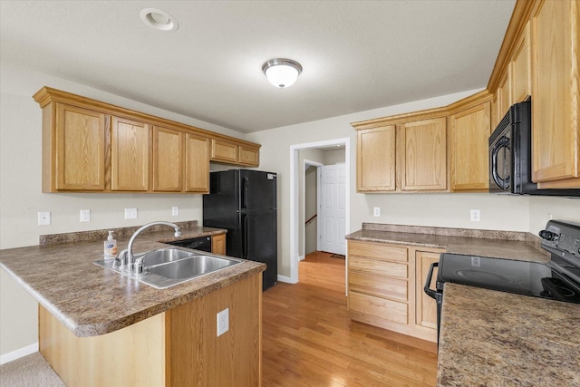 2303 Blanche Ln Unit B, Champaign, IL 61822 - kitchen with black appliances, a peninsula, light wood-type flooring, and a breakfast bar area