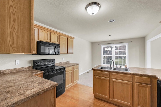 2303 Blanche Ln Unit B, Champaign, IL 61822 - kitchen featuring black appliances, light wood-style floors, a chandelier, decorative light fixtures, and a textured ceiling