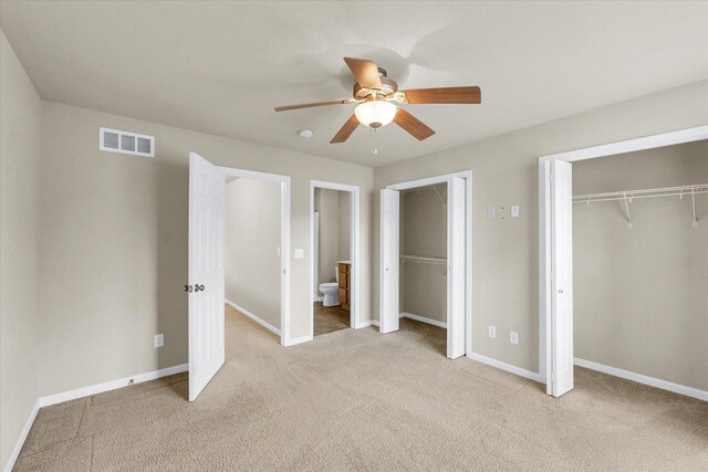 2303 Blanche Ln Unit B, Champaign, IL 61822 - unfurnished bedroom featuring light carpet, ensuite bathroom, a ceiling fan, and multiple closets