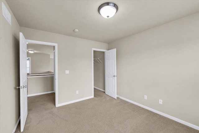 2303 Blanche Ln Unit B, Champaign, IL 61822 - unfurnished bedroom with light colored carpet, a spacious closet, and a closet