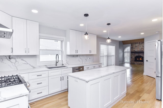 631 S Whispering Hills Dr, Naperville, IL 60540 - kitchen with a kitchen island, stainless steel appliances, decorative backsplash, recessed lighting, and white cabinetry