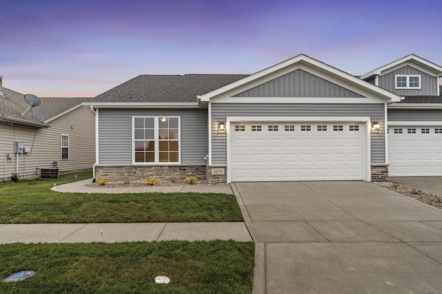 6375 Jasmine Ave, Portage, IN 46368 - view of front of home with stone siding, driveway, and board and batten siding