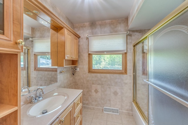 1825 W Sherry Ln, Addison, IL 60101 - full bath with tile walls, tile patterned floors, vanity, and combined bath / shower with glass door