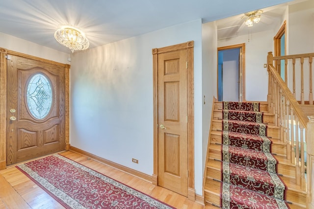 1825 W Sherry Ln, Addison, IL 60101 - entryway featuring light wood-style flooring, baseboards, stairway, and a chandelier