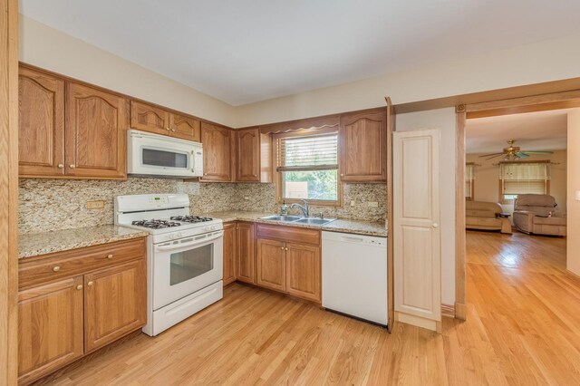 1825 W Sherry Ln, Addison, IL 60101 - kitchen with white appliances, a sink, light wood finished floors, and decorative backsplash
