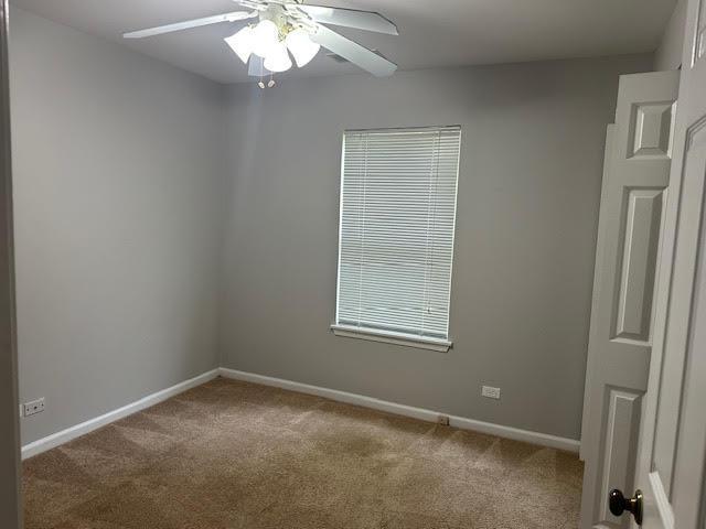 1127 Orleans Dr, Mundelein, IL 60060 - empty room featuring carpet flooring, a ceiling fan, and baseboards