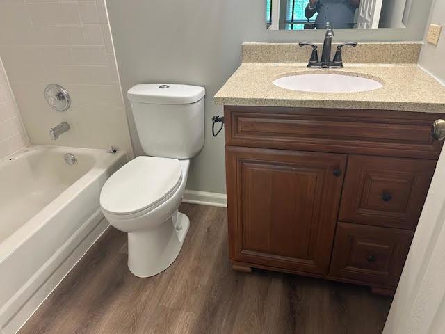 1127 Orleans Dr, Mundelein, IL 60060 - full bathroom with wood finished floors, vanity, toilet, shower / washtub combination, and baseboards