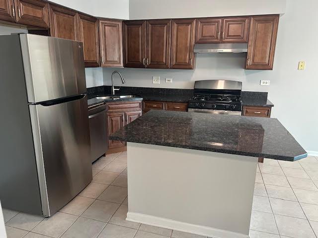 1127 Orleans Dr, Mundelein, IL 60060 - kitchen with freestanding refrigerator, range with gas stovetop, dishwashing machine, under cabinet range hood, and light tile patterned floors