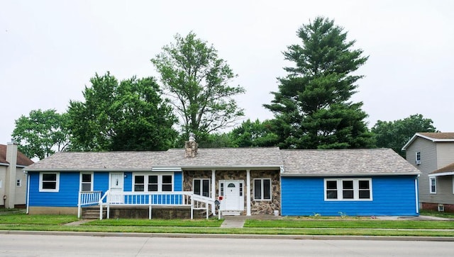 510 W Harrison St, Villa Grove, IL 61956 - ranch-style house with a porch, a front yard, a chimney, and stone siding